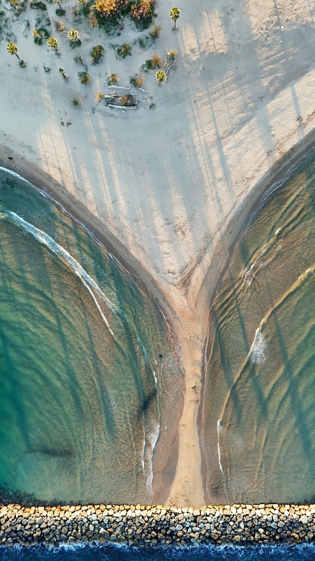 Split image of beach sand and finished computer chip
