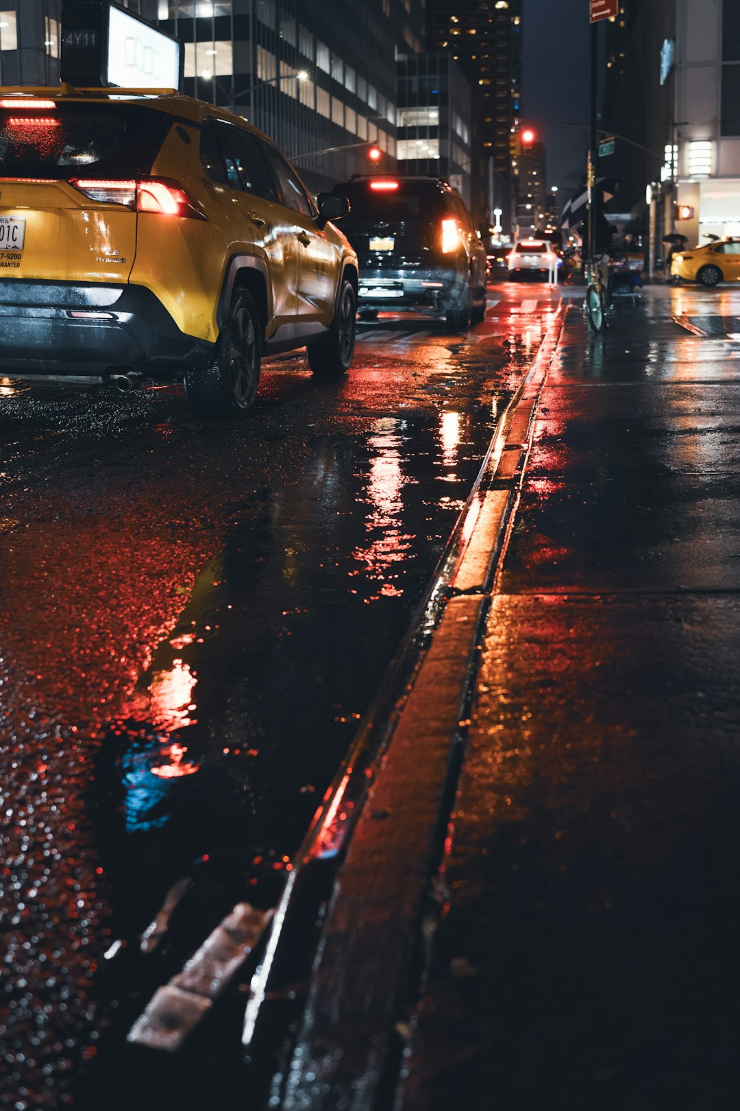 Futuristic autonomous vehicle on rainy city street at night