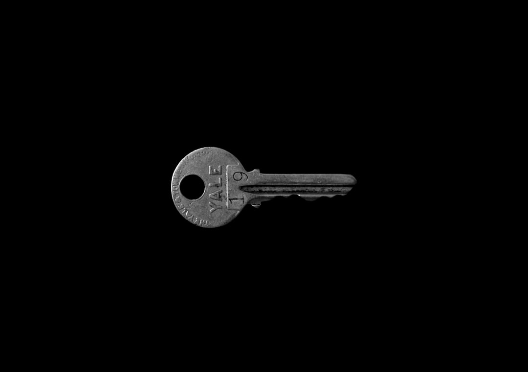 Hardware security key on dark surface with dramatic lighting