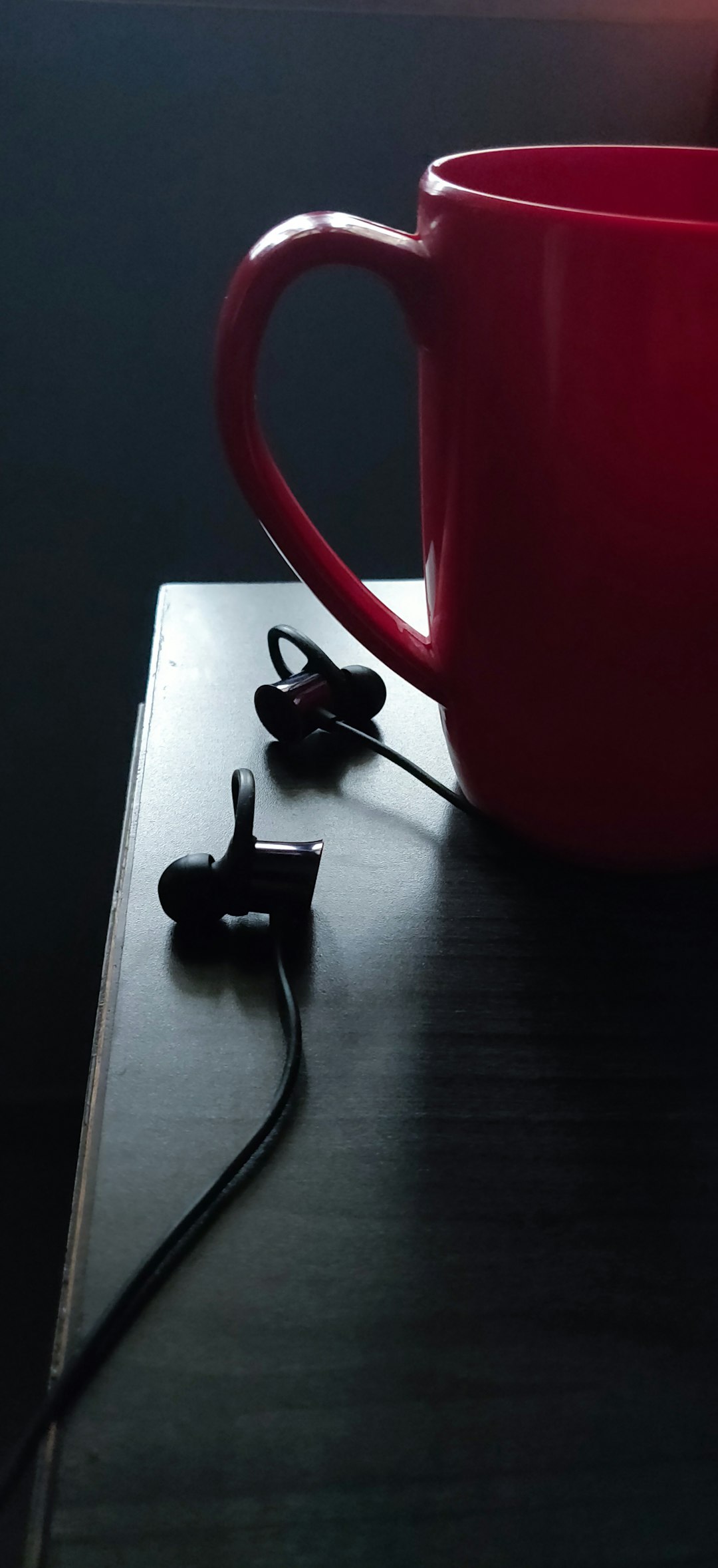 Over-ear headphone resting near rainy window