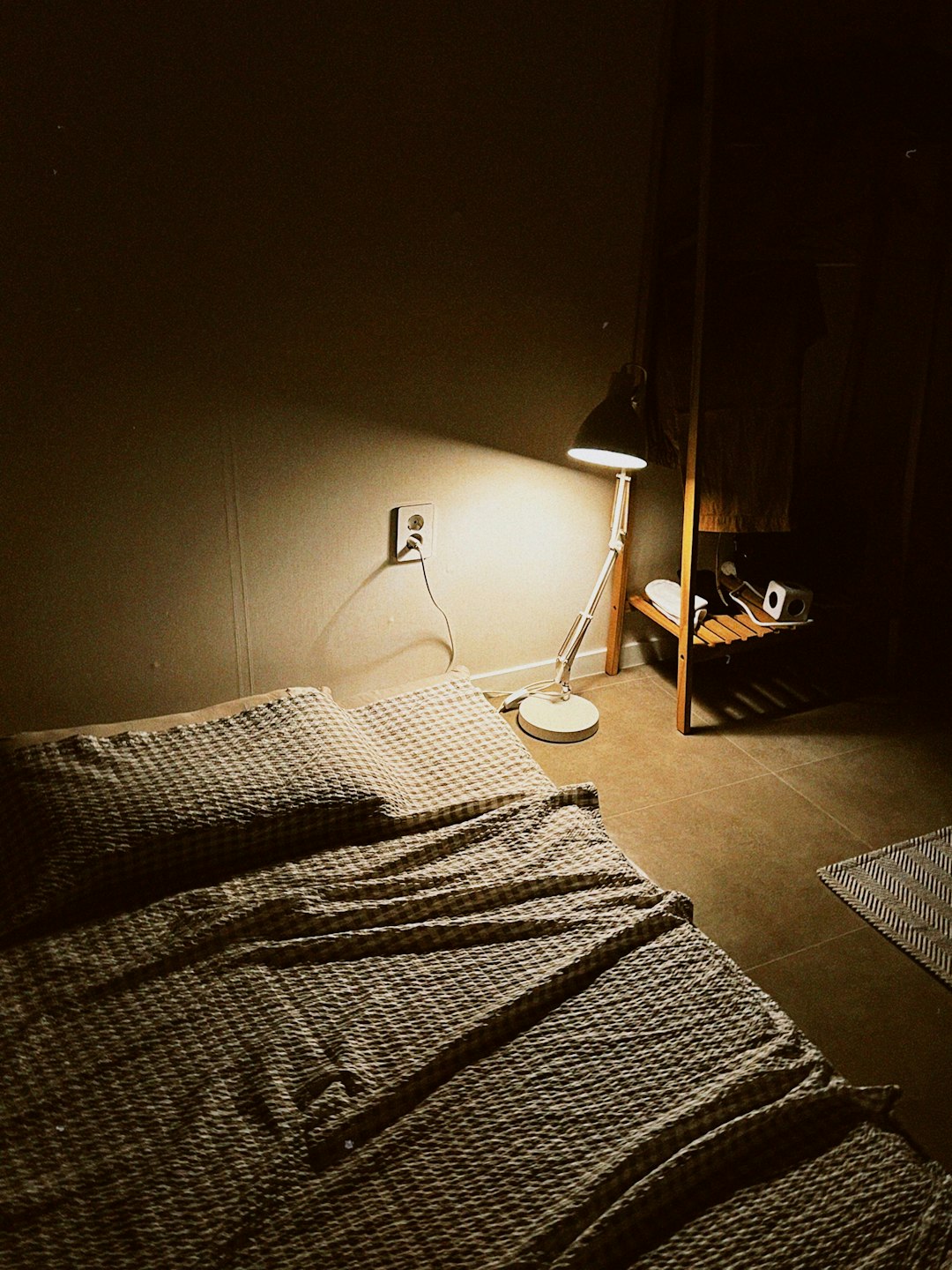 Smart devices glowing in a dark bedroom at night