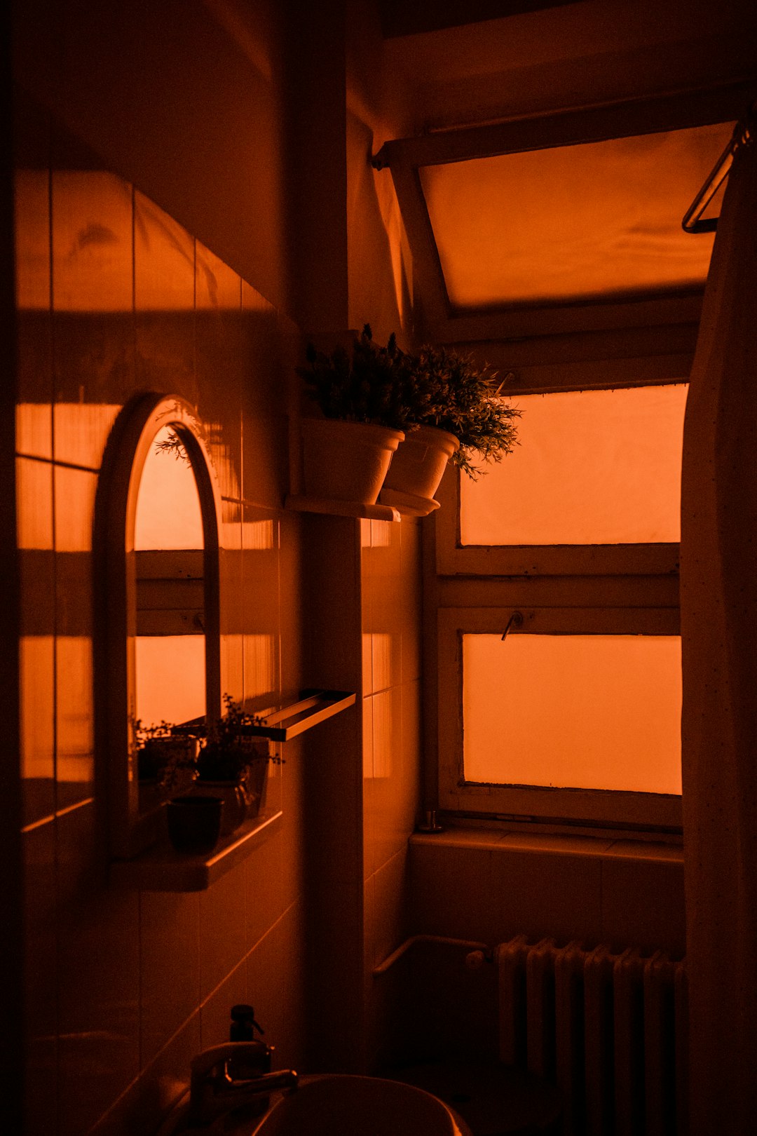 Golden hour bathroom vignette with candle, mirror, and dried botanicals