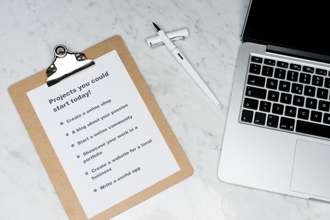 Overhead view of cybersecurity checklist and laptop on desk