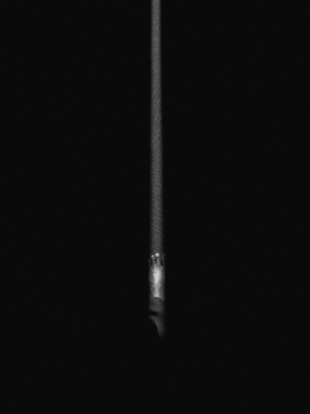 Single illuminated RAM stick standing upright on dark background