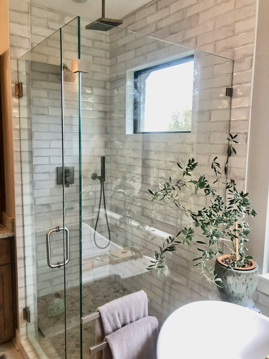 Vertical Pinterest-style small bathroom with travertine walk-in shower