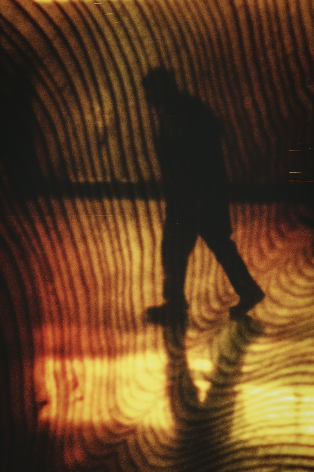 Human silhouette before large optical illusion wall