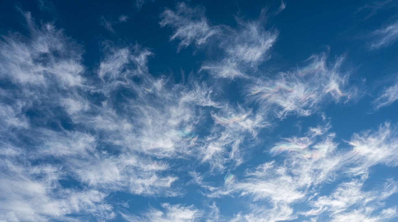 Looking up through cirrus cloud showing color bands