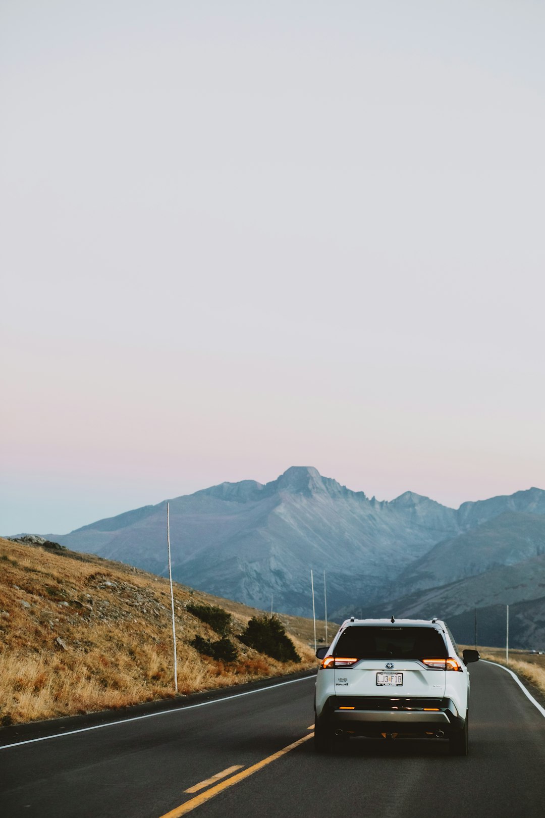 Hydrogen fuel cell vehicle on mountain road at sunrise