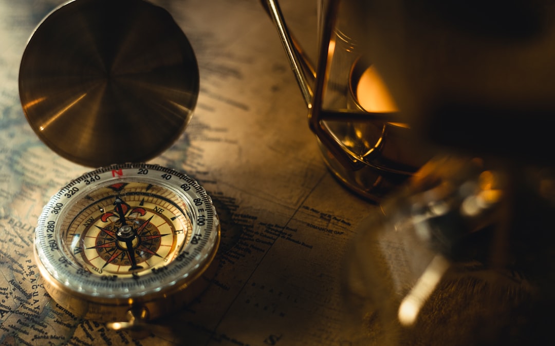 Vintage compass on topographic map showing magnetic navigation