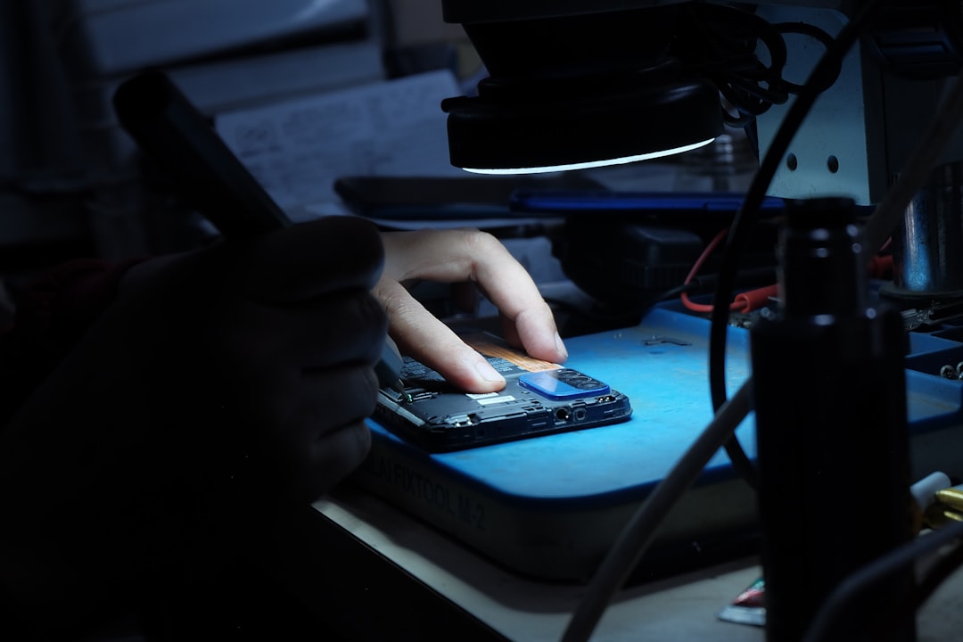 Electronics repair workbench with phones and batteries