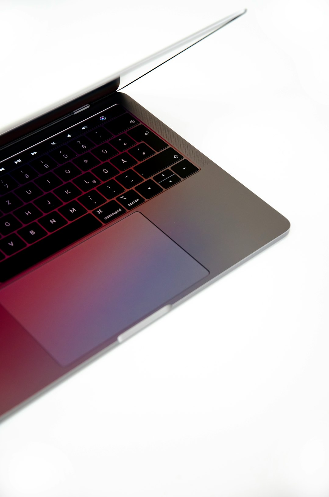 Laptop on white surface with dramatic side lighting