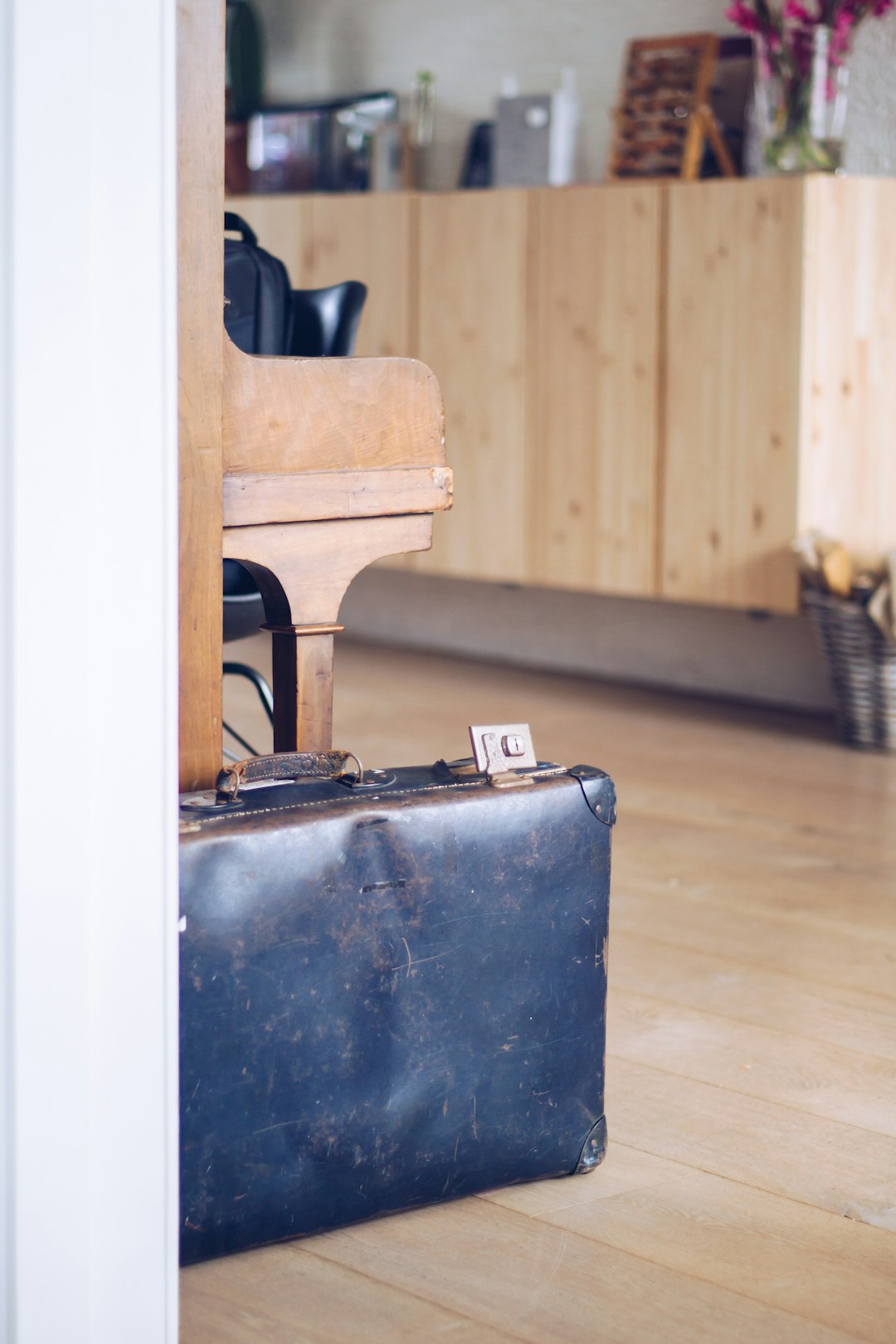 Open camera bag with gear on wooden floor