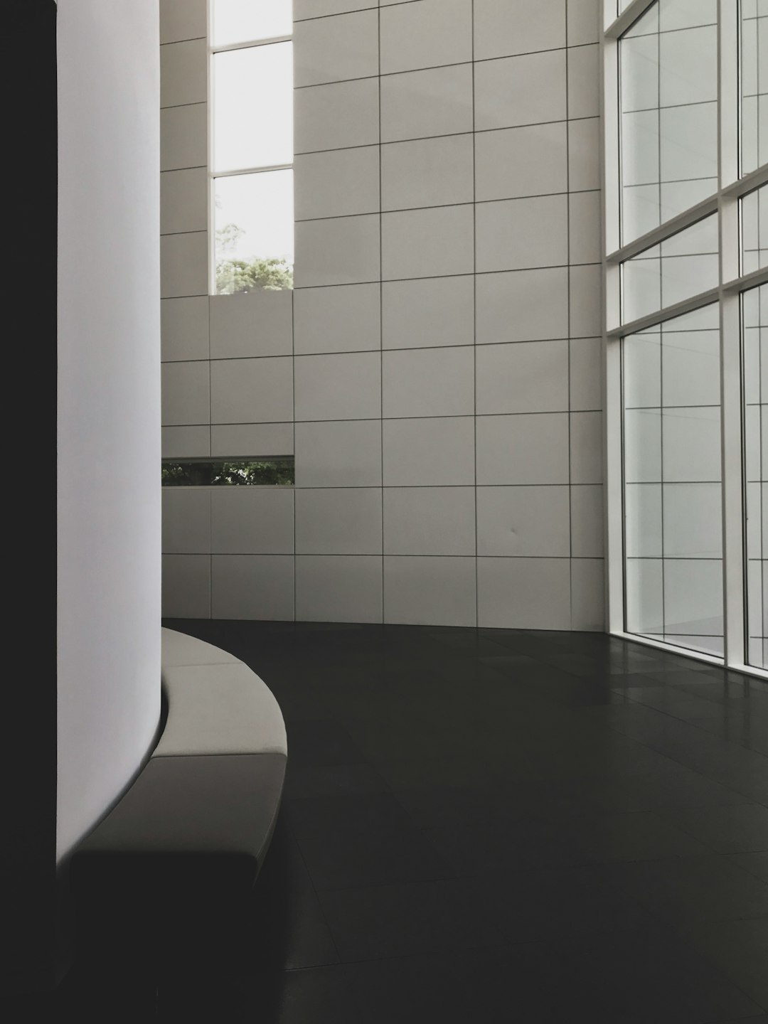 Close-up of matte white wall tiles and textured floor tiles in minimalist bathroom