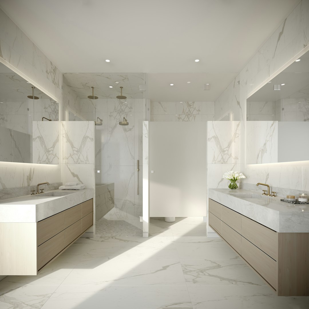 Marble wall tiles with charcoal hexagonal floor tiles in a modern bathroom