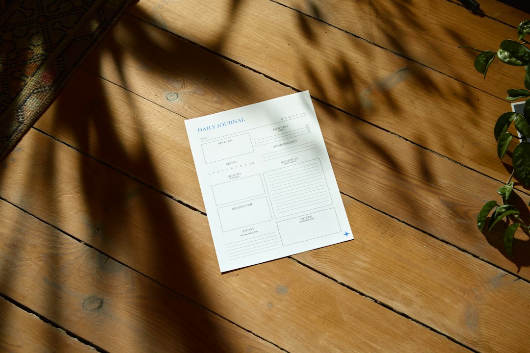 Seasonal plant care checklist with tools and autumn leaves flat lay